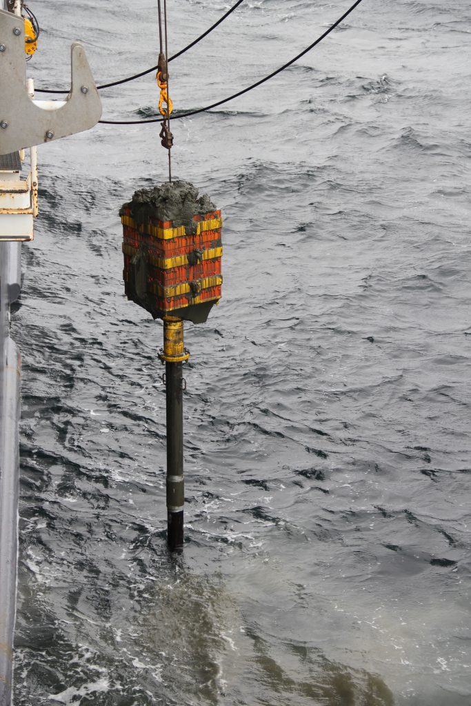 A piston core filled with marine sediments coming up in the Denmark Strait aboard G.O. Sars. Photo credit: Ida Olsen